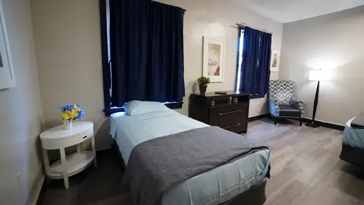Cozy bedroom with two beds at Unlimited Bounds Human Services detox center in Maryland.