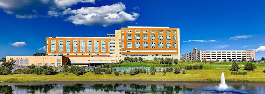 Modern facility exterior with pond at Adventist HealthCare Rehabilitation, an intensive outpatient program in Maryland.