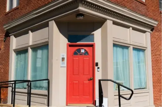 Bright red door of Earl's Place Transitional Housing, a sober living home in Maryland.