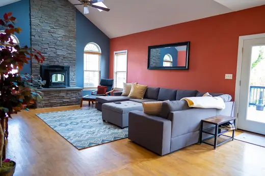 Cozy living room with stone fireplace at Severn Home, a sober living home in Maryland.