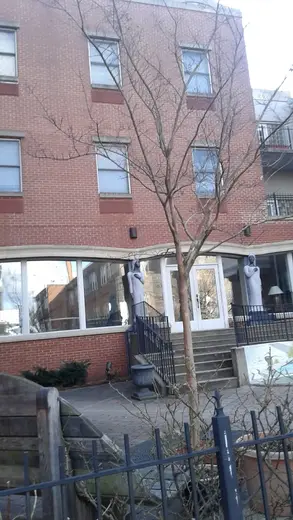 Brick exterior with large windows at Marian House, a sober living home in Maryland.